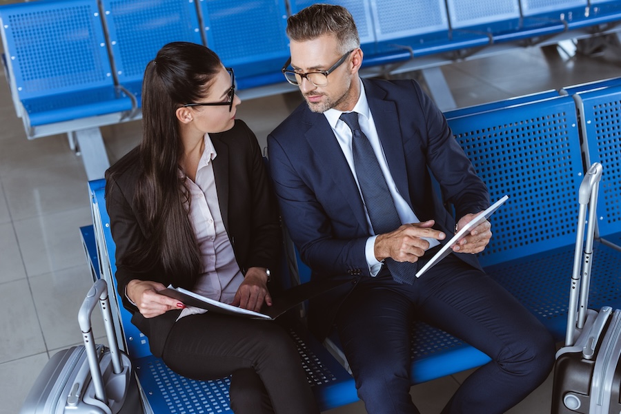 Two businesspeople in discussion at a stadium