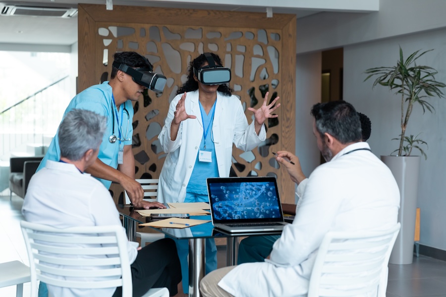 Diverse male and female doctors using VR headsets