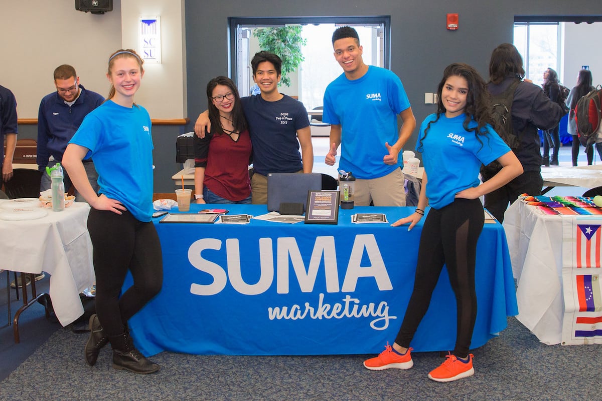 Students around SUMA Marketing table at the club fair