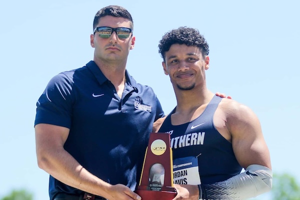 Jordan Davis, track star, holding an award