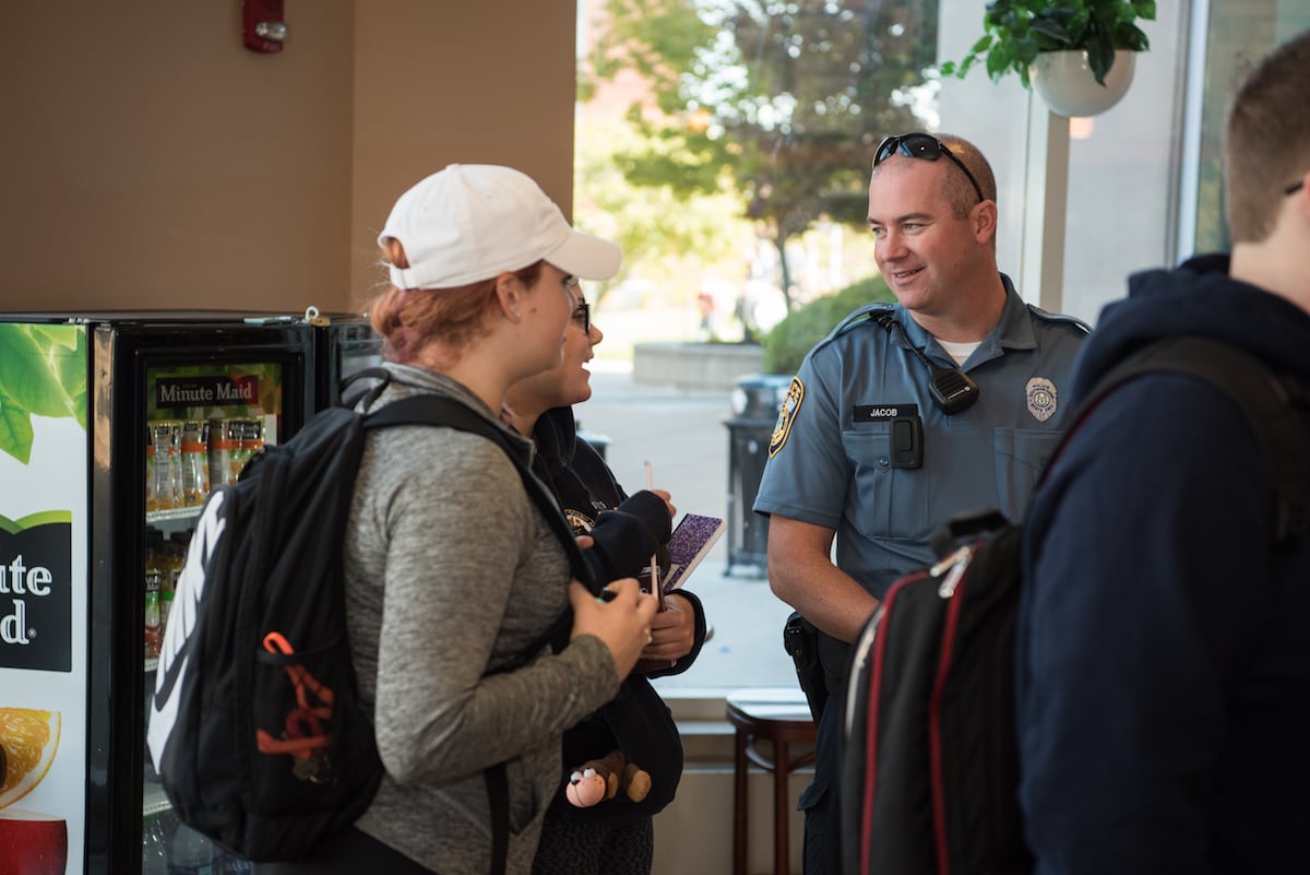 University Police officer in conversation with students
