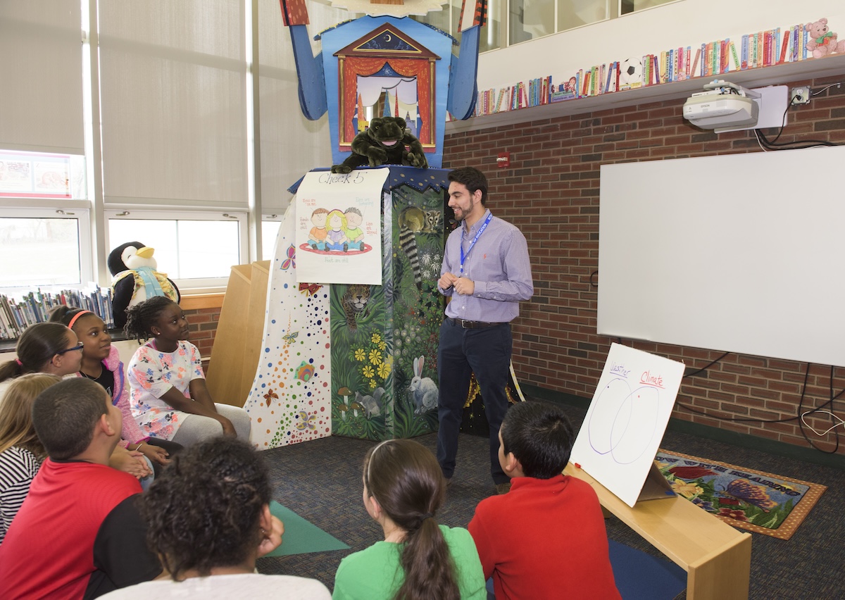 Male teacher in a classroom with kids