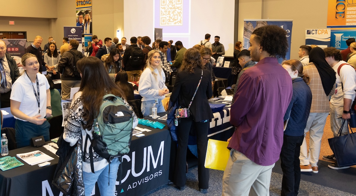 Attendees and booths at a career fair