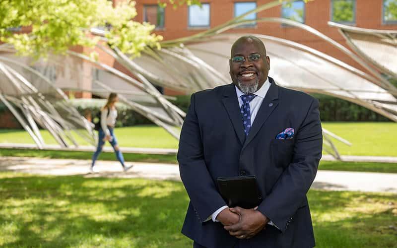 Interim President Dwayne Smith stands on the SCSU campus