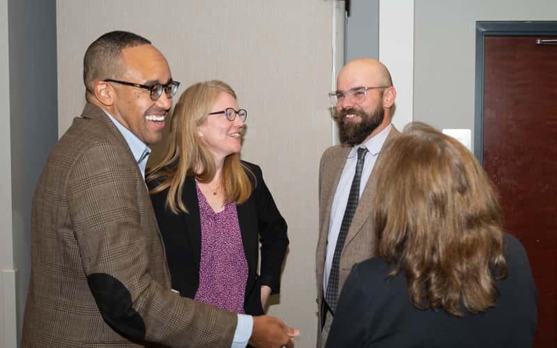 professors Jonathan Wharton and Jodie Gil speak with friends and colleagues