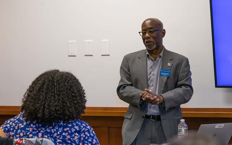 Professor of Journalism Frank Harris III speaks to a student