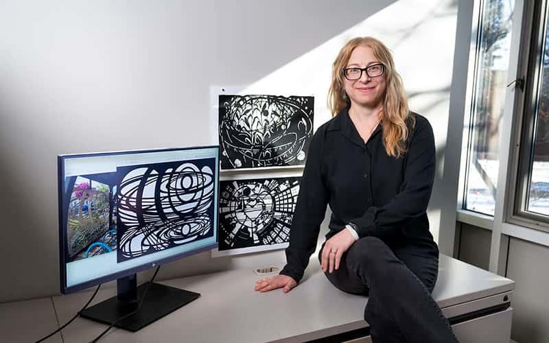 Art and Design Professor Mia Brownell with images of the three designs she created for the bicycle shelters in Geneva, N.Y.