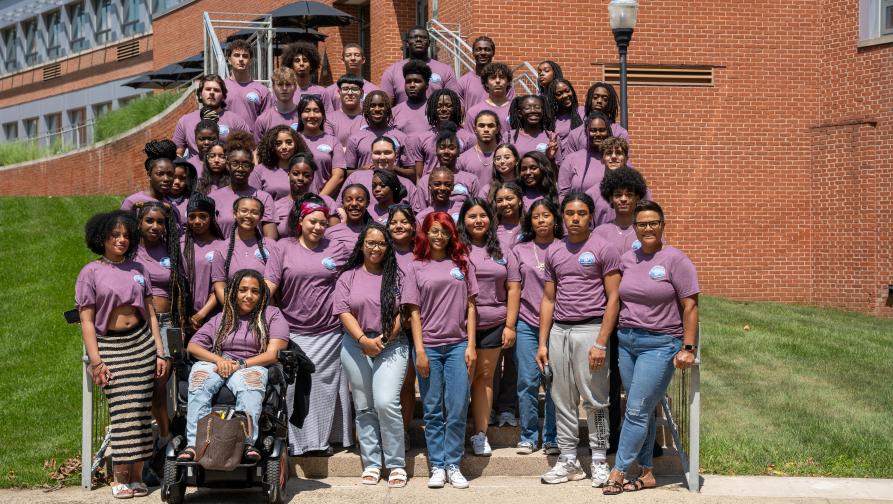 A group of students and teachers who are members of SEOP standing outside of Engleman Hall steps.