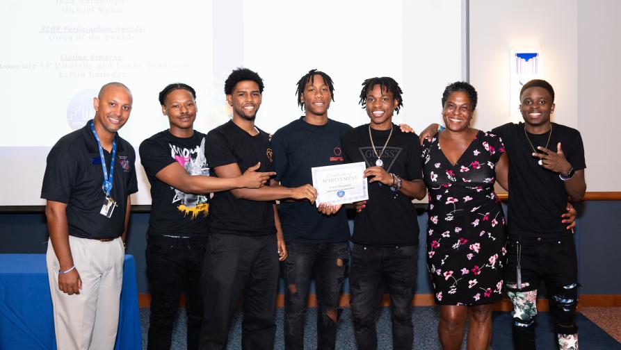 Students receiving an award at a UAP Event.