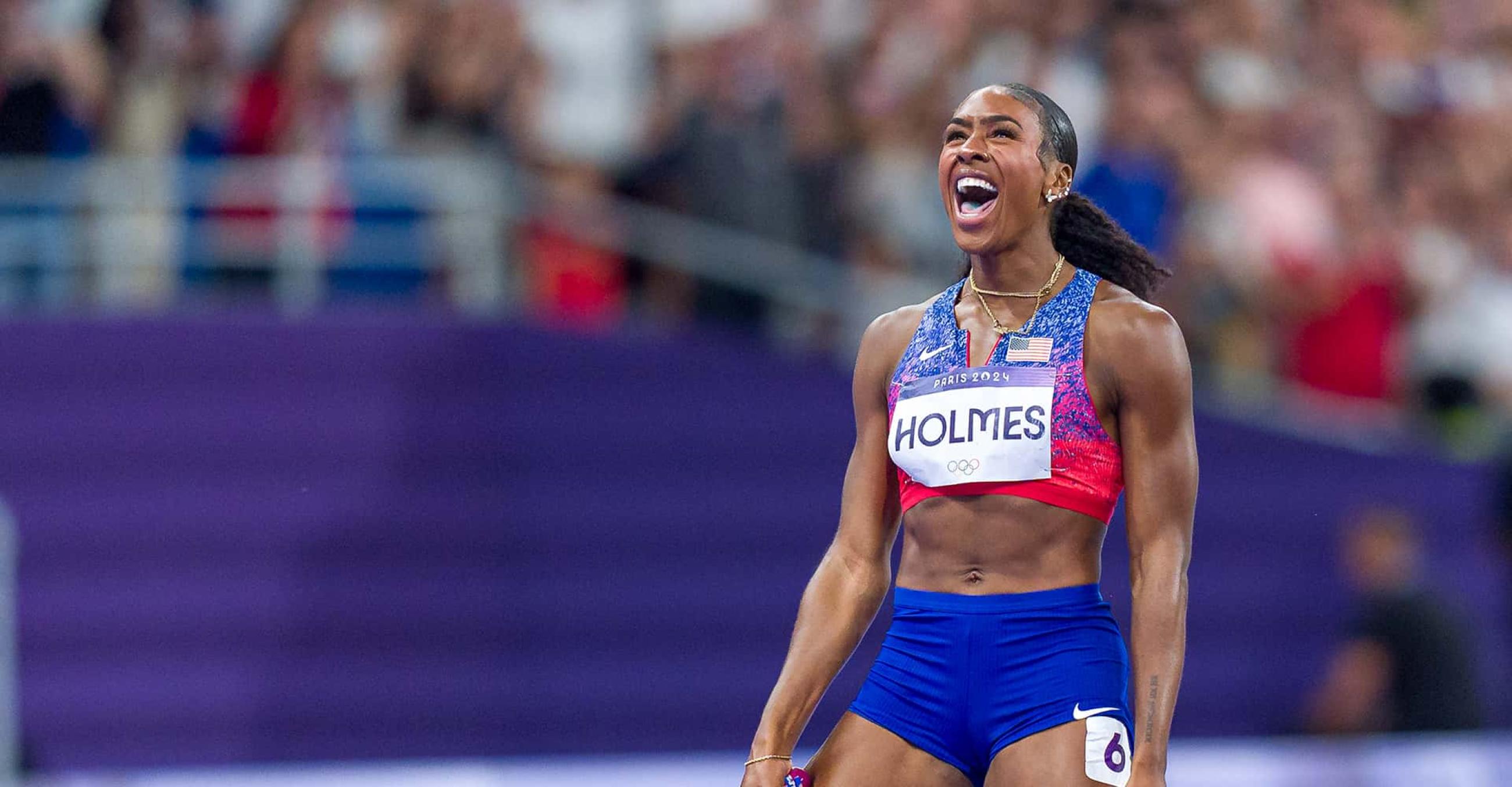 Olympic athlete Alexis Holmes rejoices after crossing the finish line