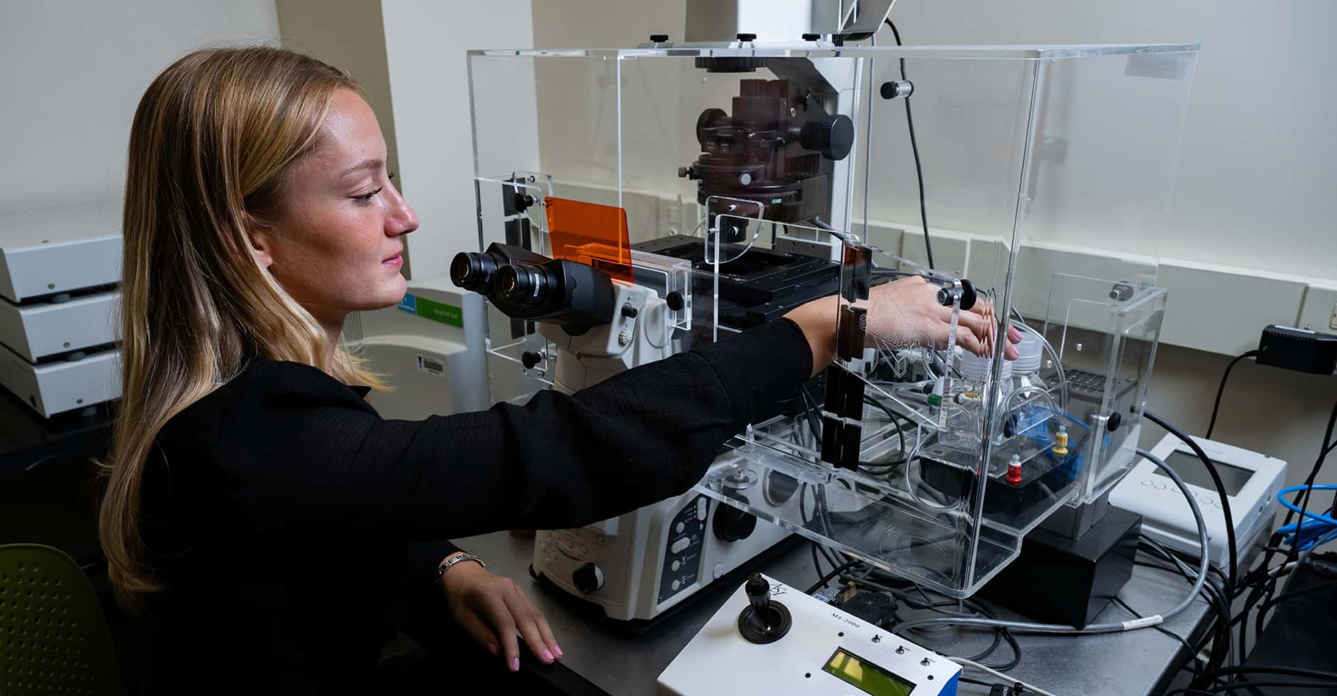 a student works with lab equipment