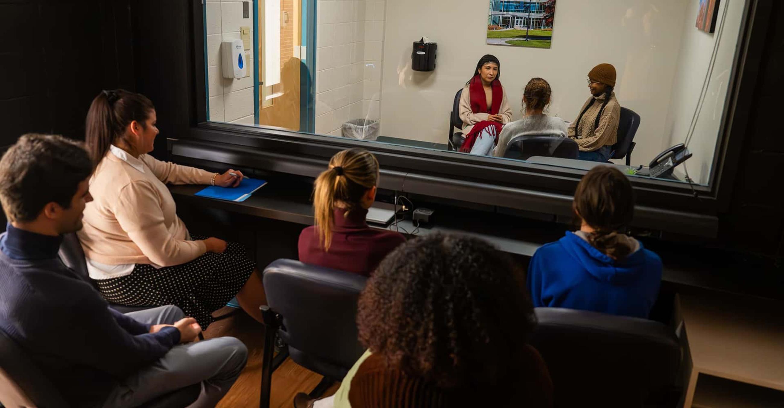 Marriage and Family Counseling students demonstrate the use of a therapy lab with an observation room for teaching.