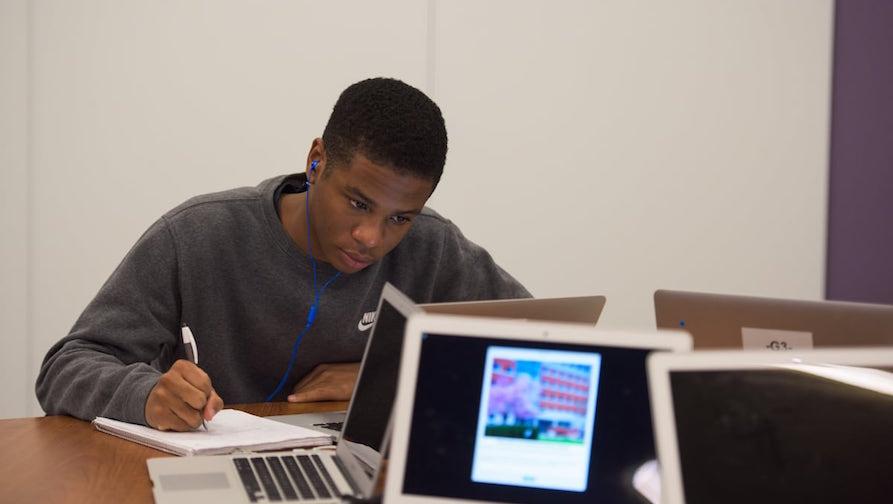 Student studying by computer